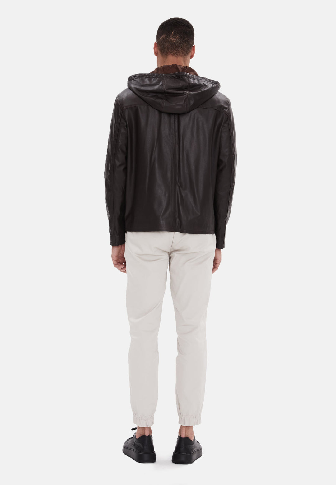 Man wearing black leather hooded jacket (back)