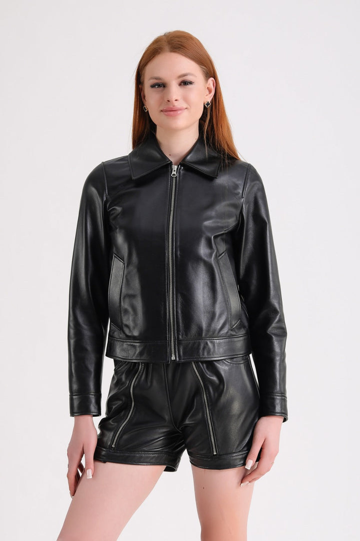 Woman in black leather jacket and shorts