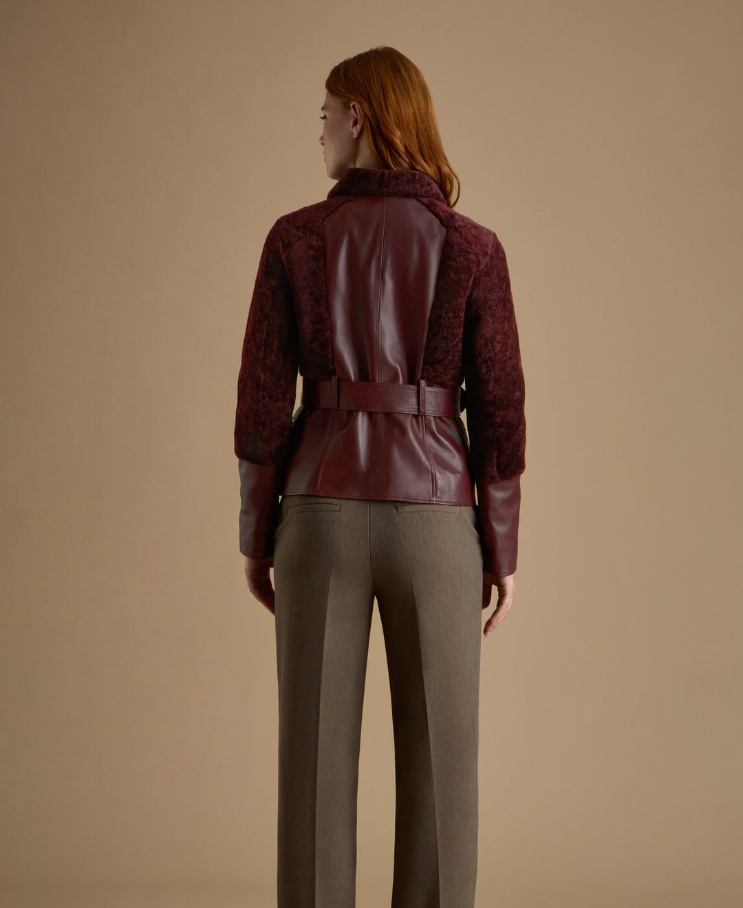 Back view of Alice burgundy leather and shearling jacket with sculpted silhouette