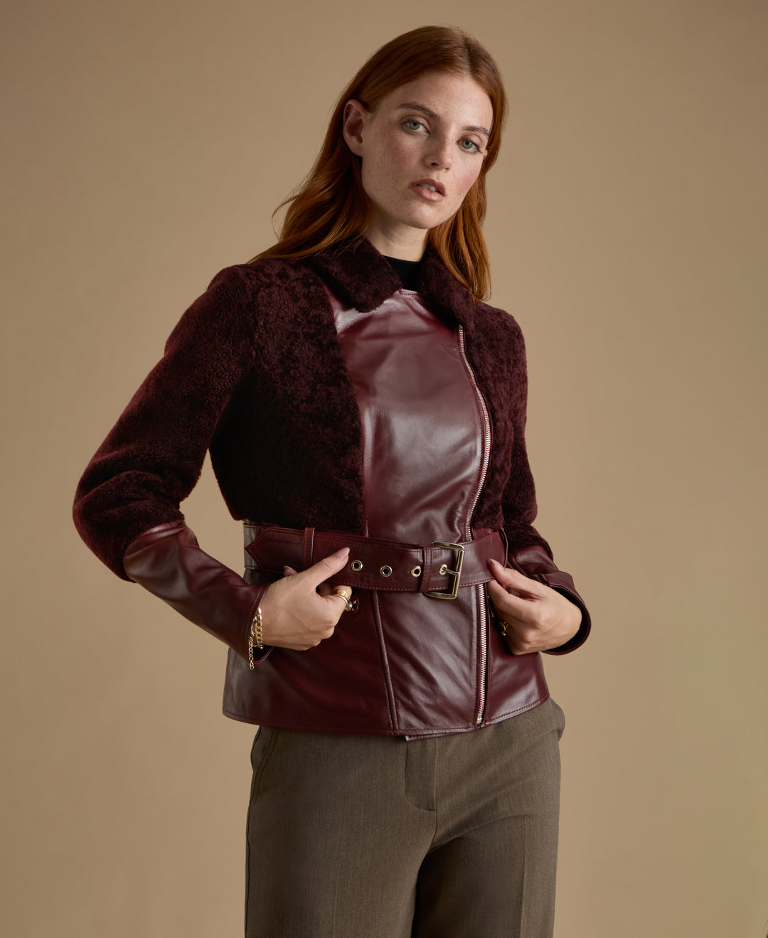 Close-up of Alice burgundy leather and shearling jacket with asymmetric zip detail