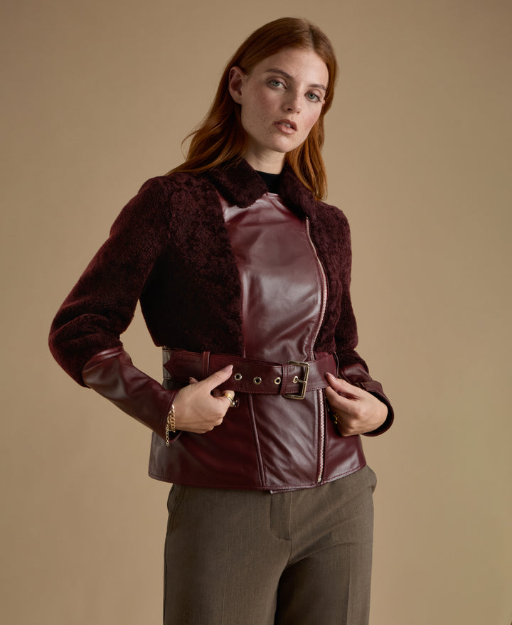 Close-up of Alice burgundy leather and shearling jacket with asymmetric zip detail