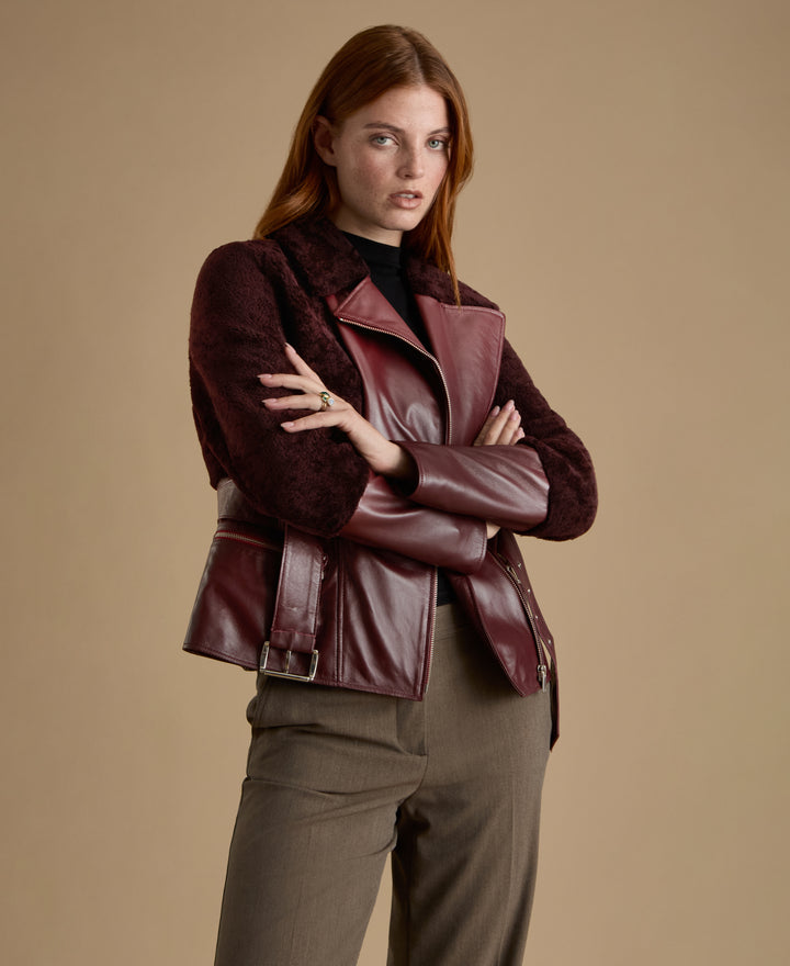 Woman wearing Alice burgundy leather and shearling jacket from FURNIQ UK Fall Winter 2026/27 collection