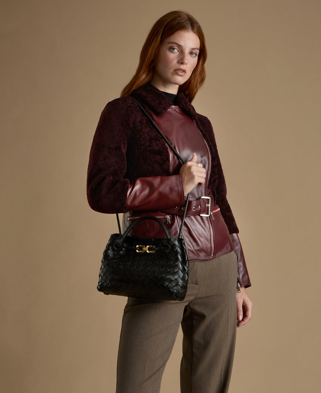 Alice burgundy leather and shearling jacket styled with black woven leather handbag