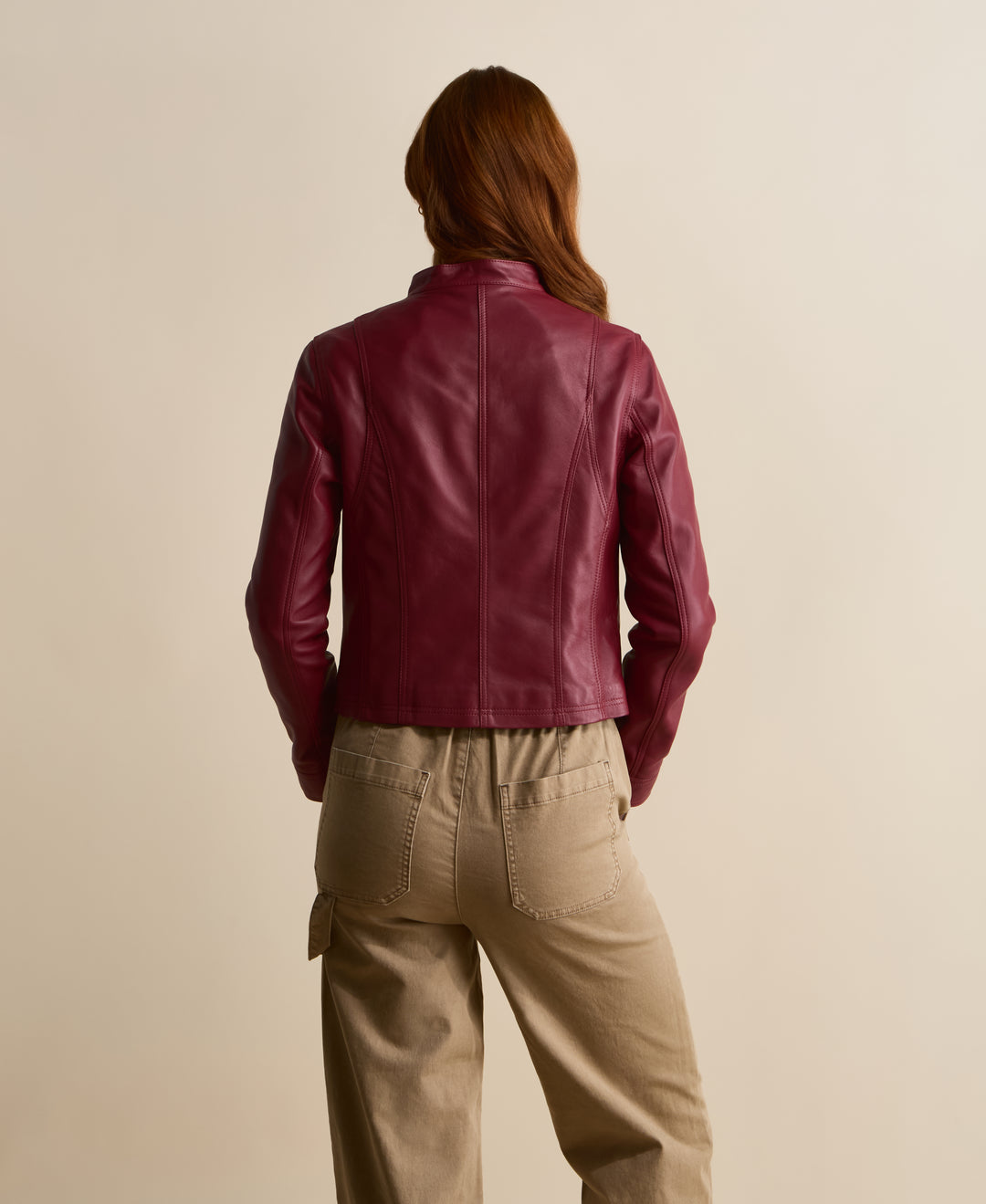 Back view of Amelia light burgundy leather jacket showing tailored seam detailing
