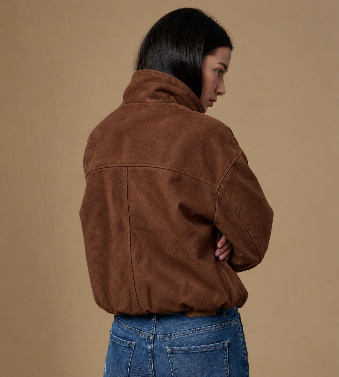 Back view of the Arden chestnut brown suede jacket showing dropped shoulders, panel seams and gathered hem.