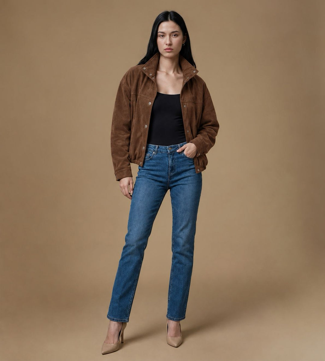 Full-length styling of the Arden chestnut brown suede jacket with blue jeans and pointed-toe heels.