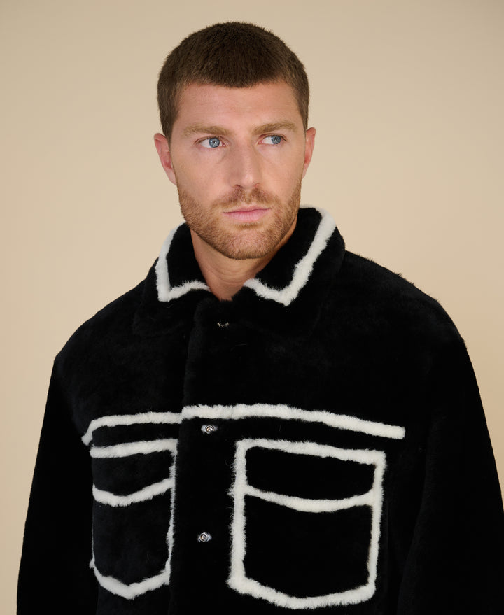 Ashton men's black shearling jacket detail showing contrast shearling seams