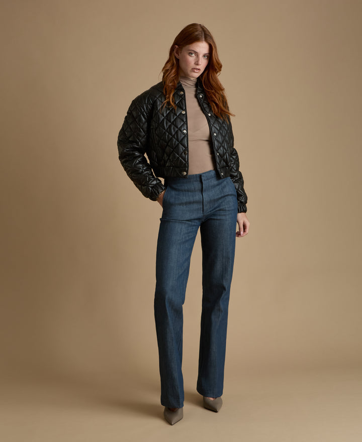 Full-length view of Aveline black quilted leather jacket