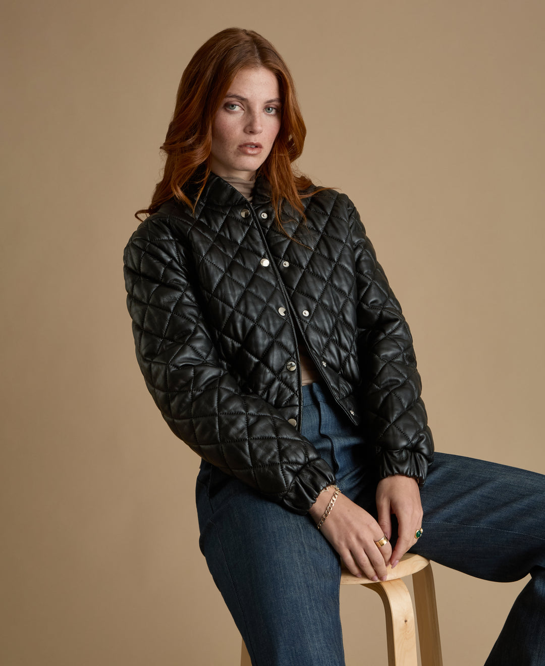 Aveline black quilted leather jacket styled with tailored denim trousers