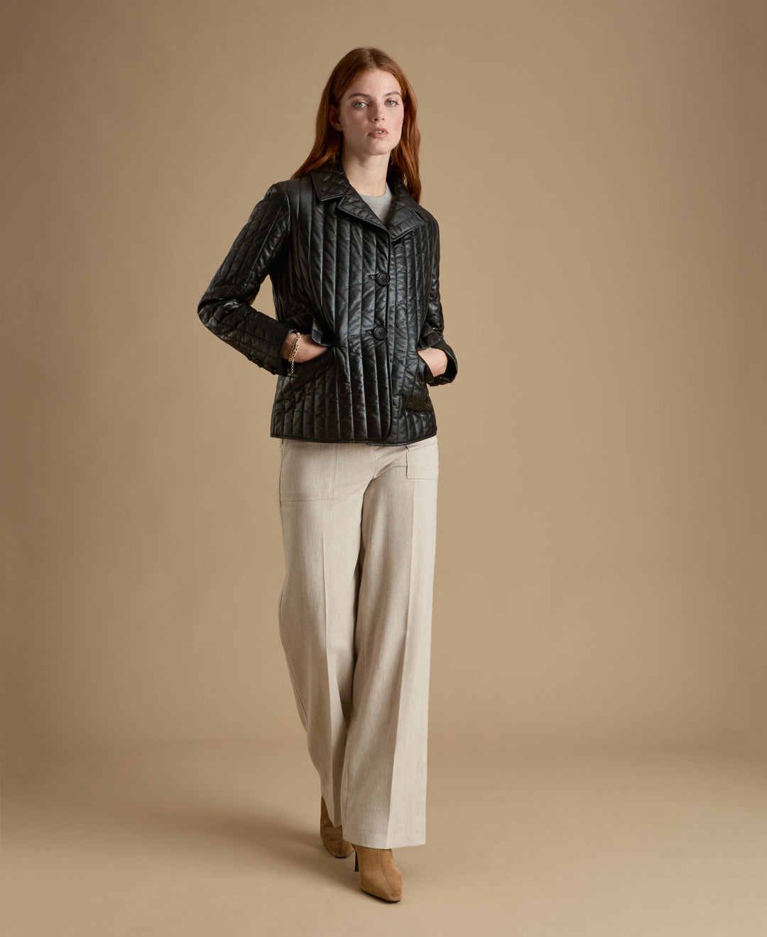 Woman wearing black quilted leather coat