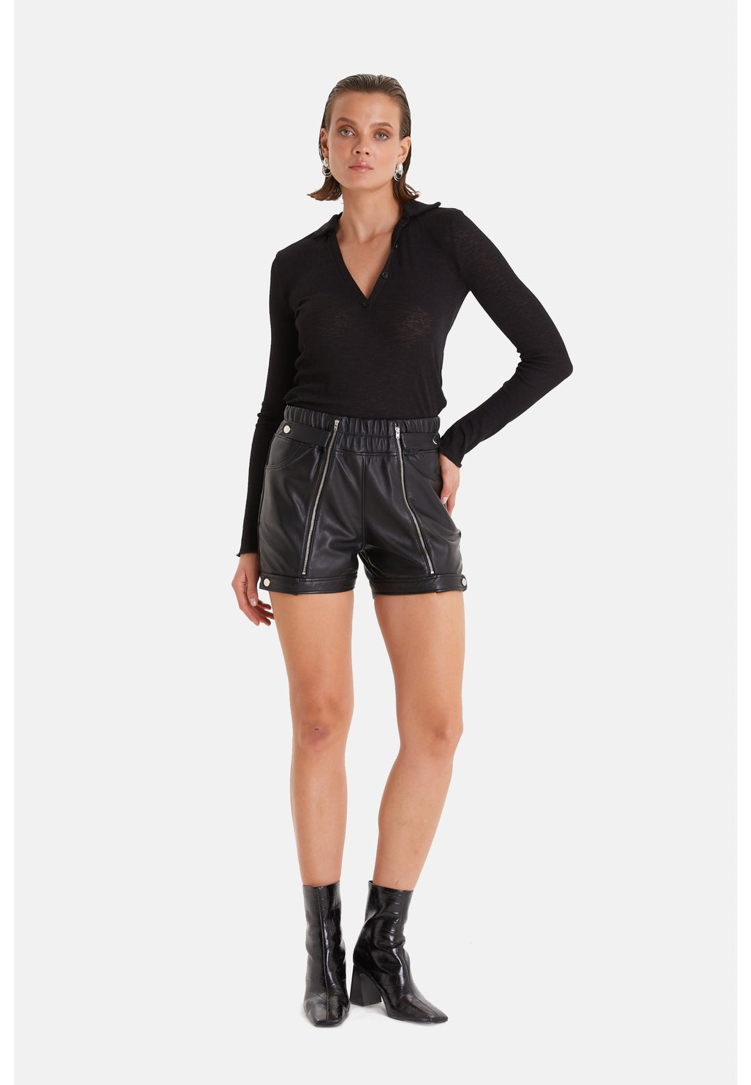 Woman wearing black leather shorts