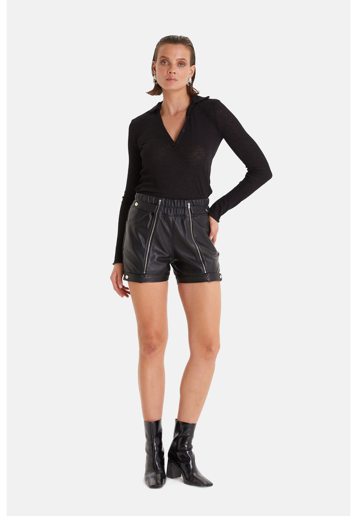 Woman wearing black leather shorts