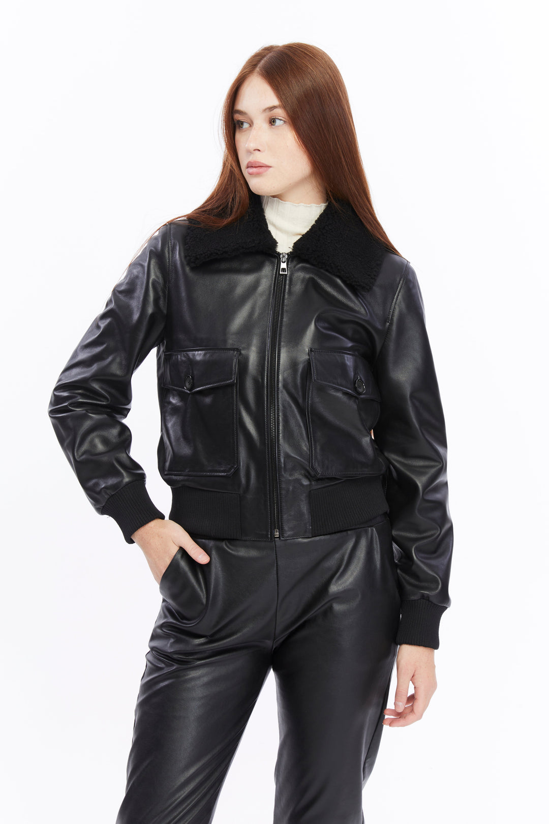Female model wearing black leather bomber jacket