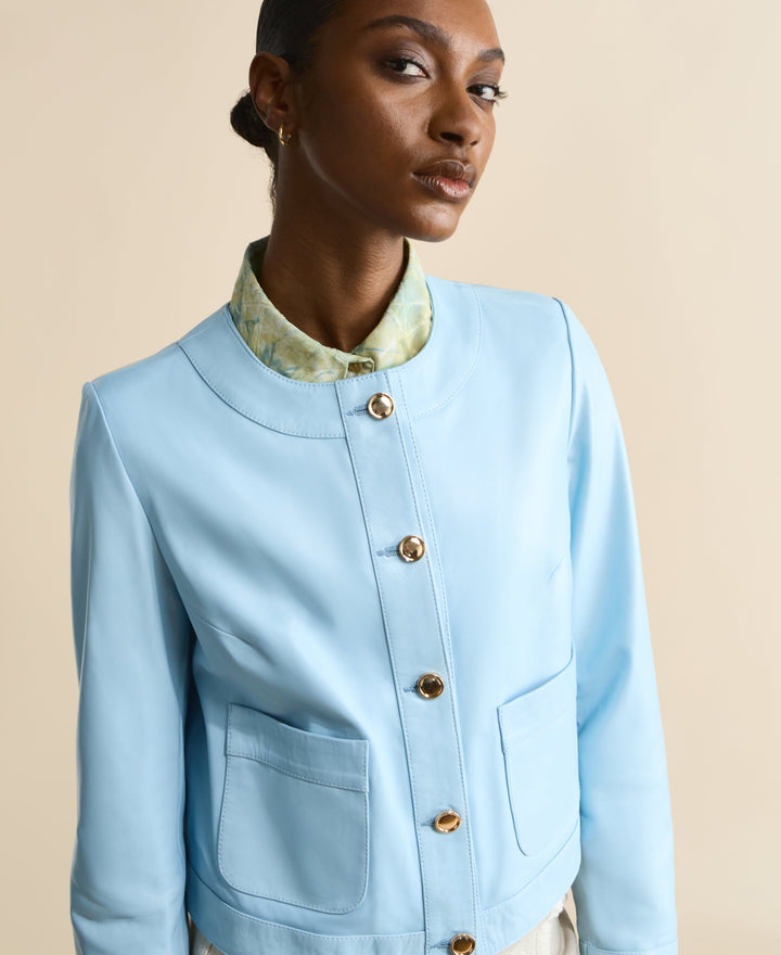 Light blue collarless leather jacket with gold buttons