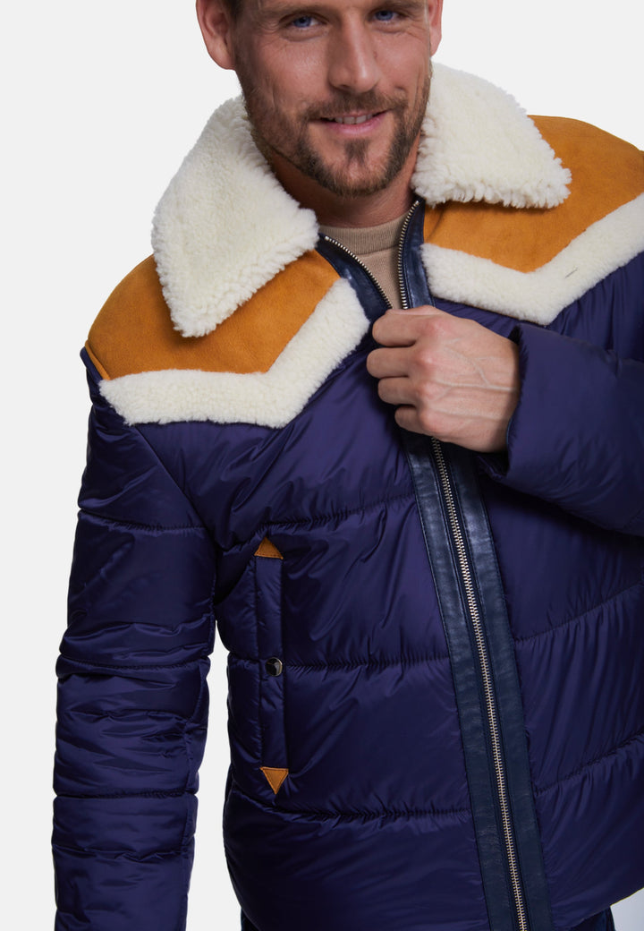 Male model wearing navy puffer coat with shearling