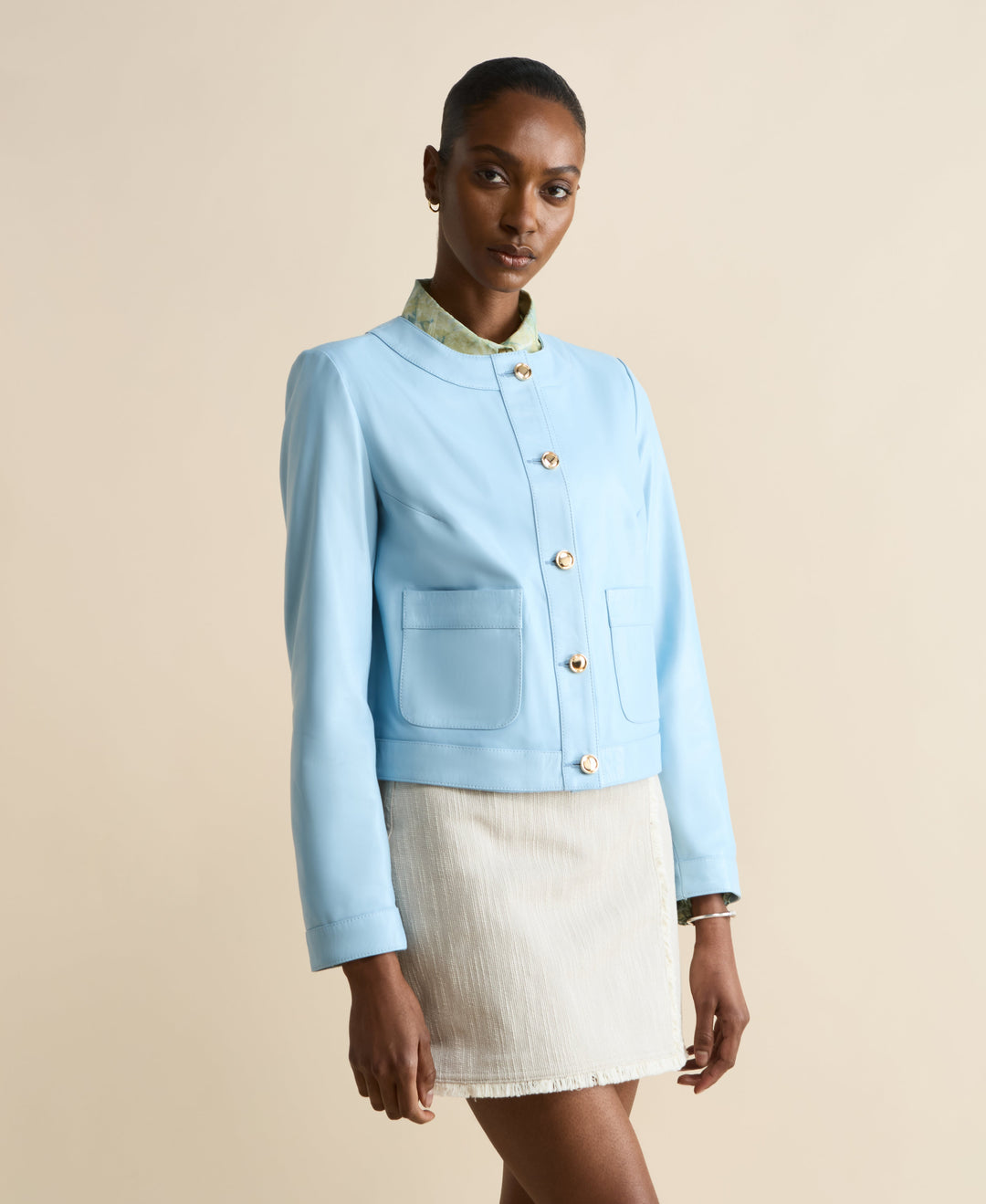 Light blue collarless leather jacket
