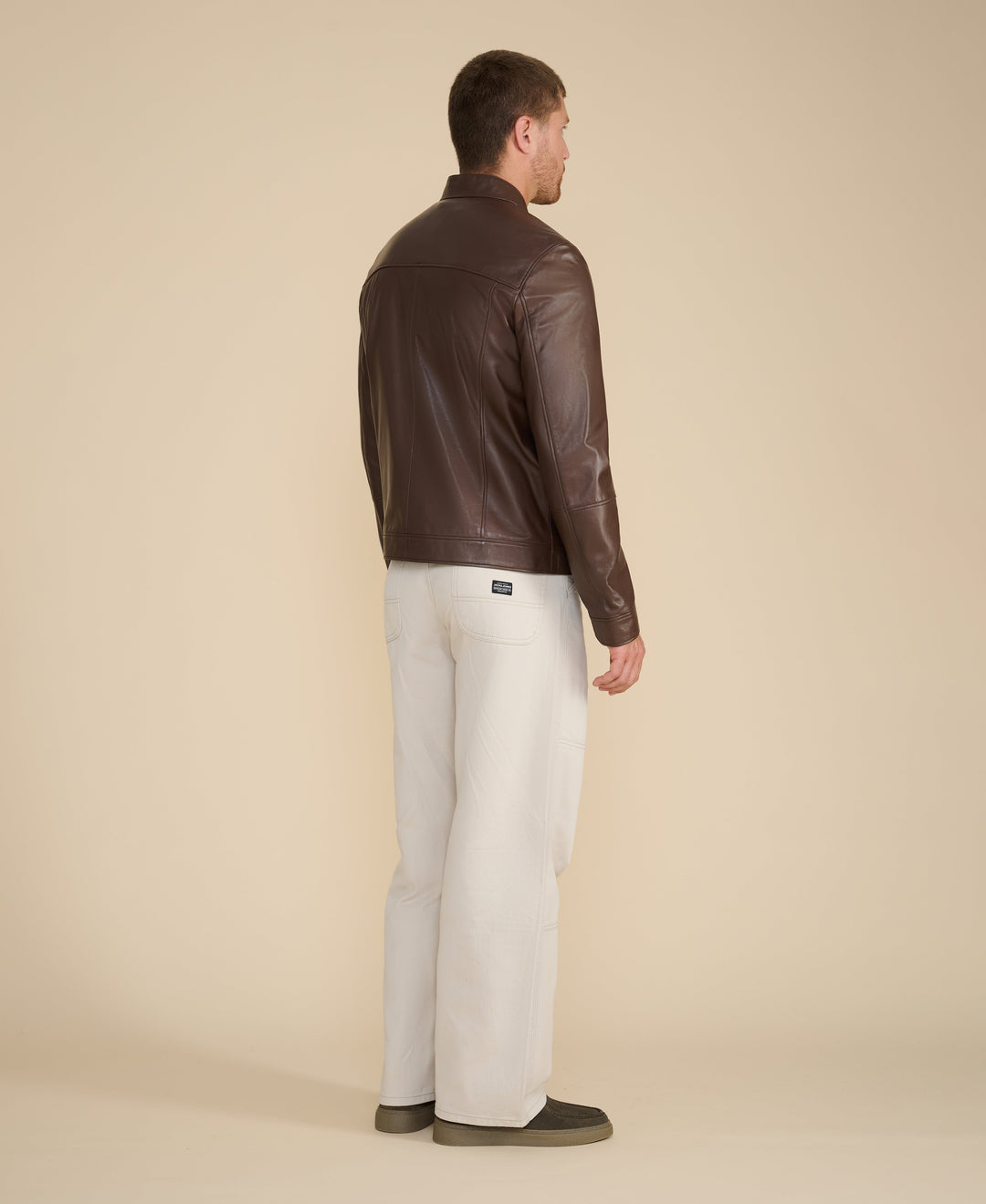 Man wearing brown leather jacket (back)