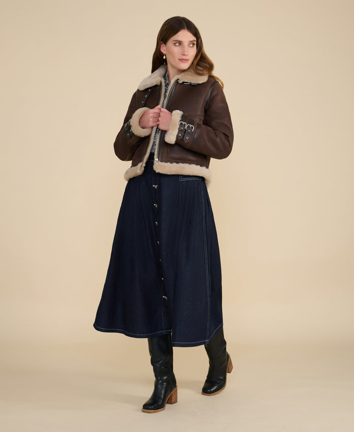 Woman wearing the Briar vintage brown sheepskin aviator jacket with cream shearling trim by FURNIQ UK