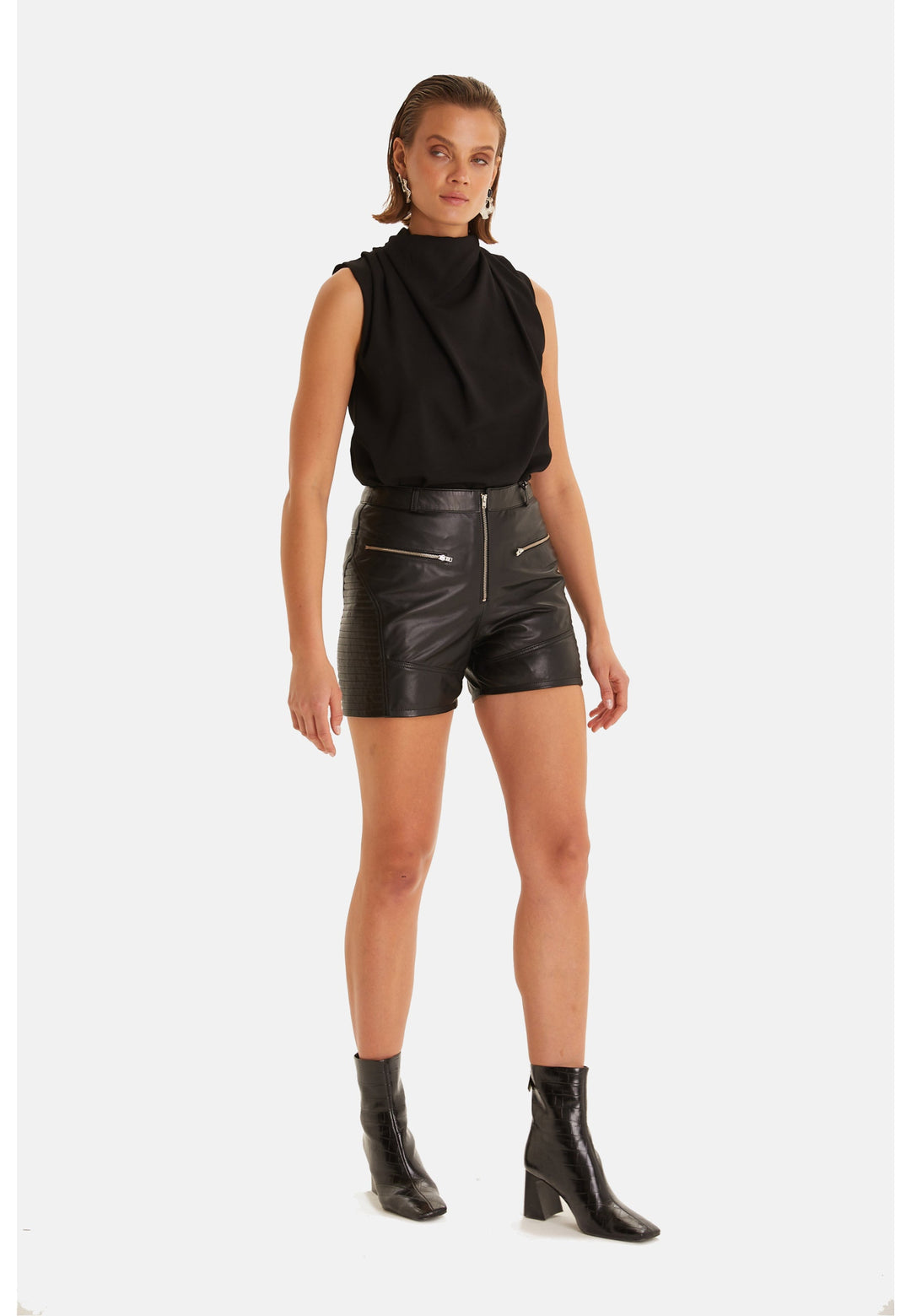 Woman wearing black leather shorts