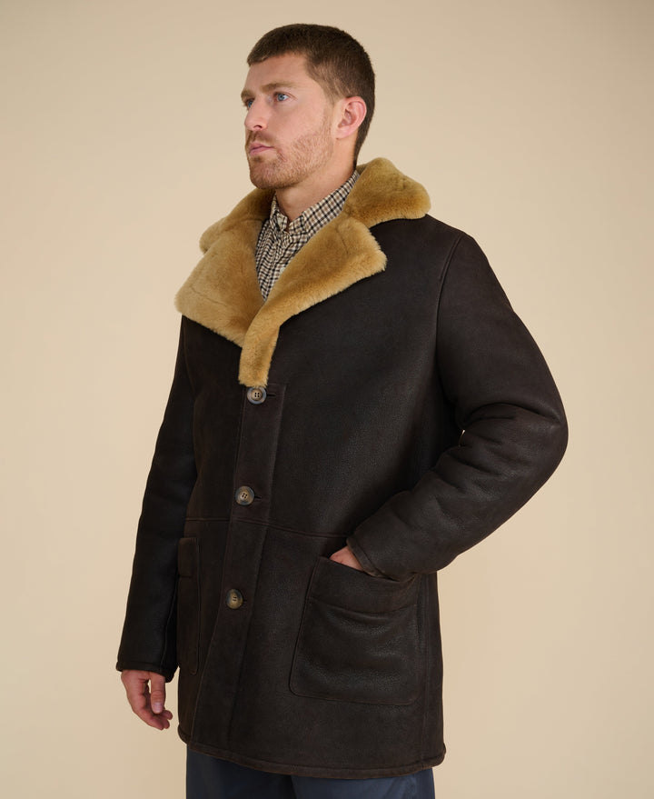 Man wearing dark brown shearling coat