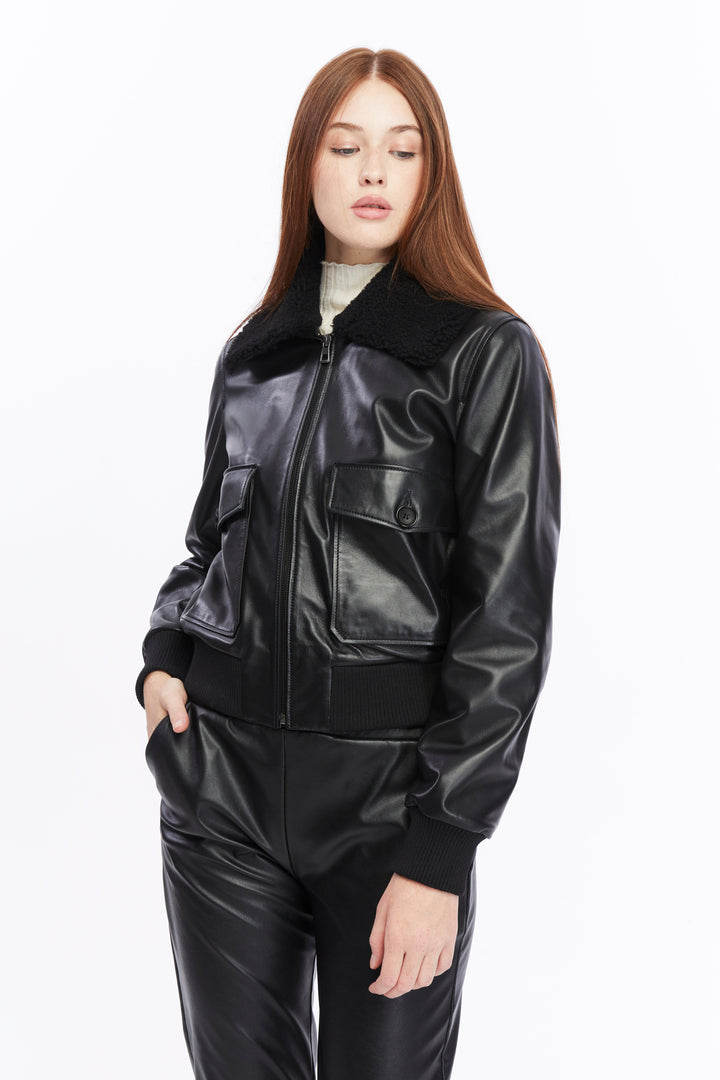 Woman wearing black leather bomber jacket