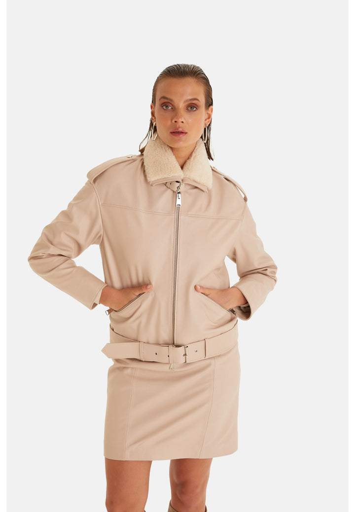 Woman wearing beige belted leather jacket