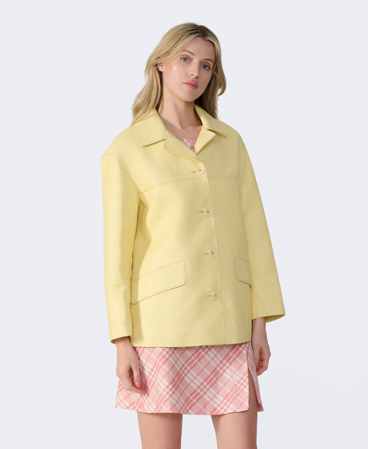 Woman wearing pastel yellow leather jacket
