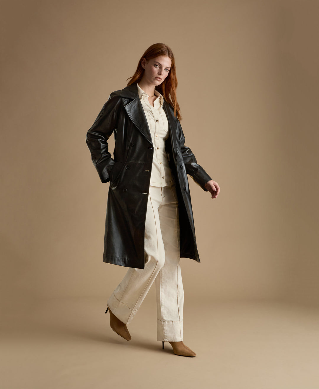 Woman wearing black leather trench coat