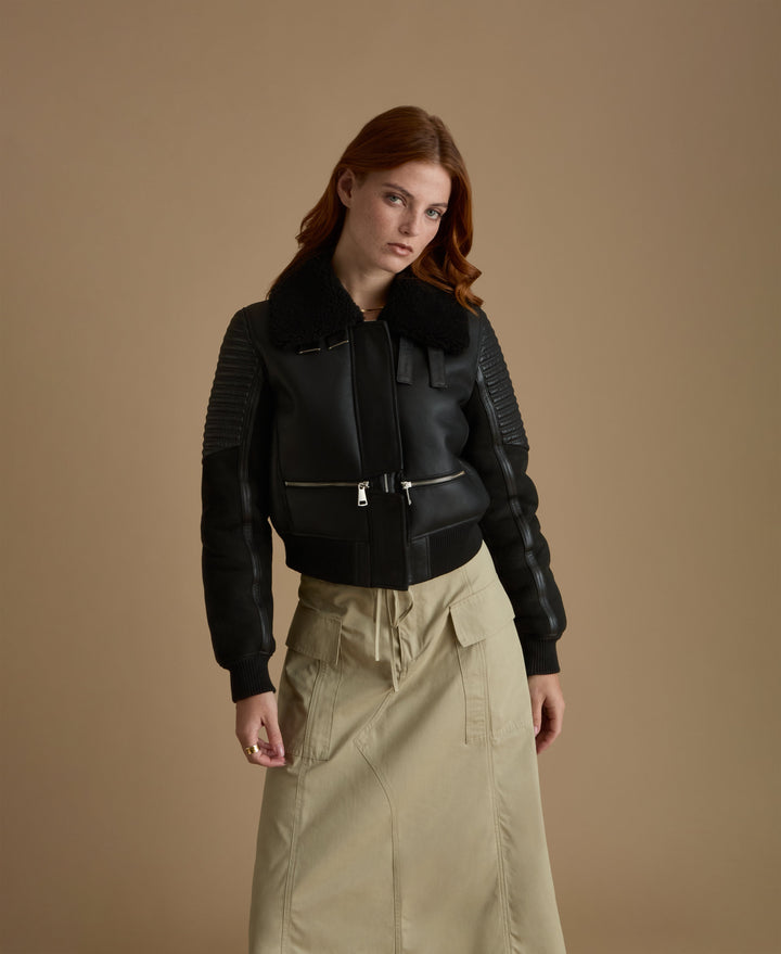 Woman wearing black shearling jacket