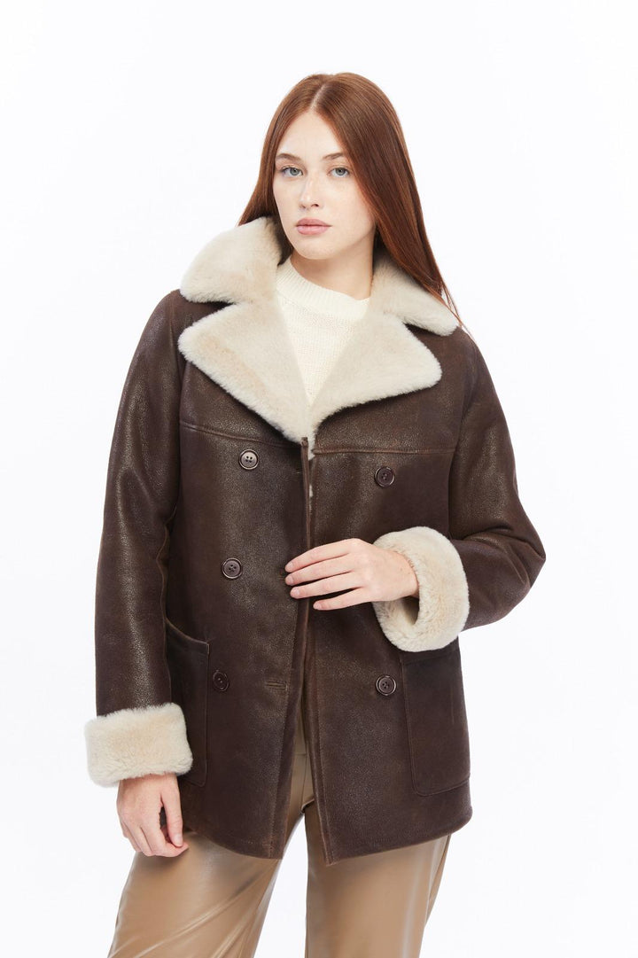 Chelsea brown shearling peacoat showing plush cream shearling lapels, cuffs and button fastening
