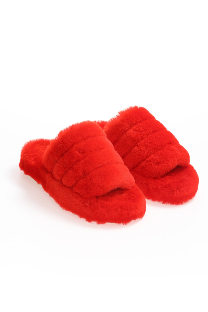 Pair of red shearling slip-on slippers