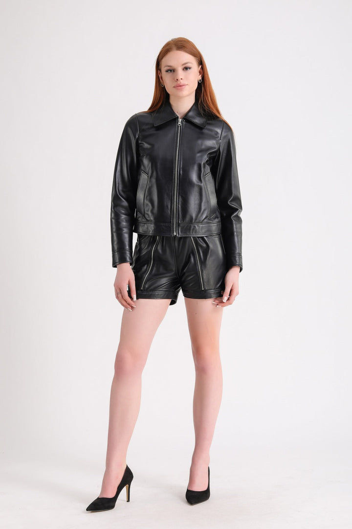 Woman in black leather jacket and shorts