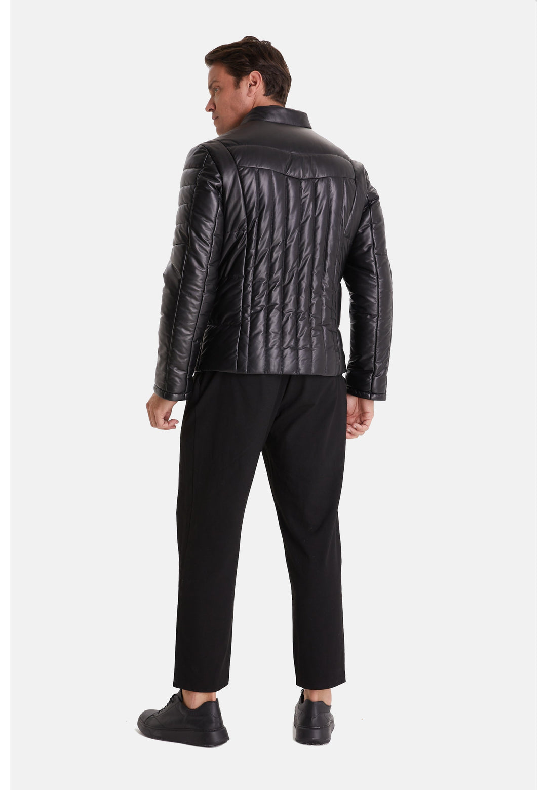 Male wearing black quilted leather jacket