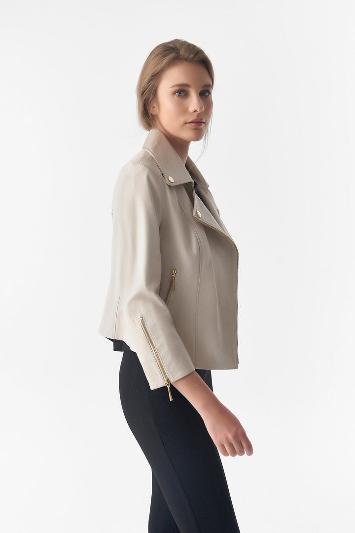 Woman wearing beige leather moto jacket