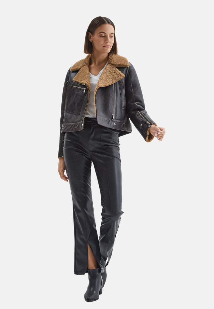 Woman wearing cropped shearling jacket