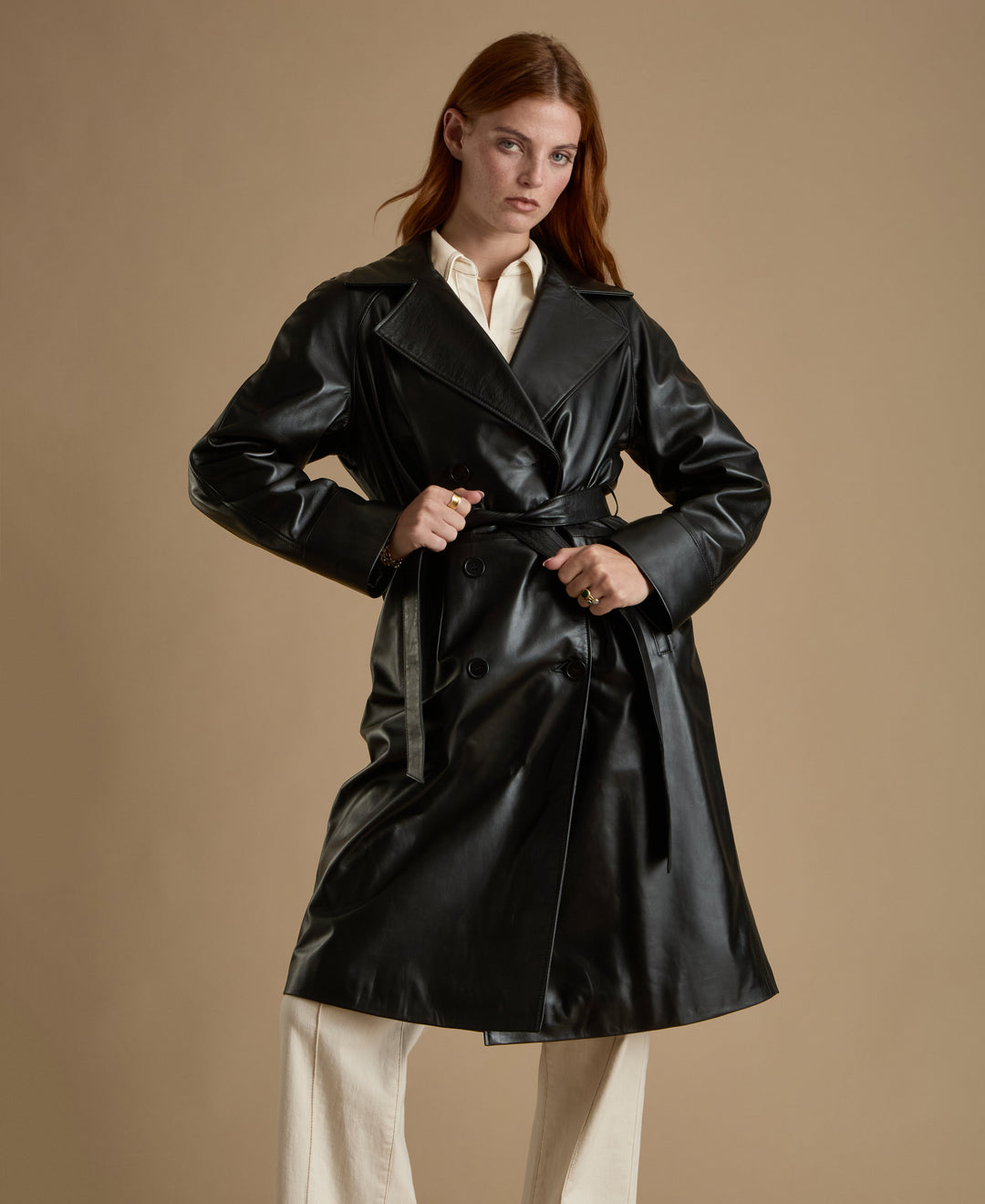 Woman wearing black leather trench coat