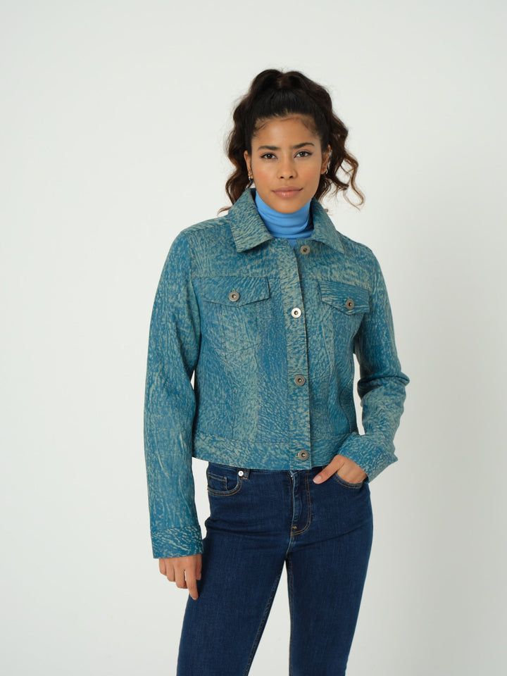 Woman wearing teal patterned leather jacket