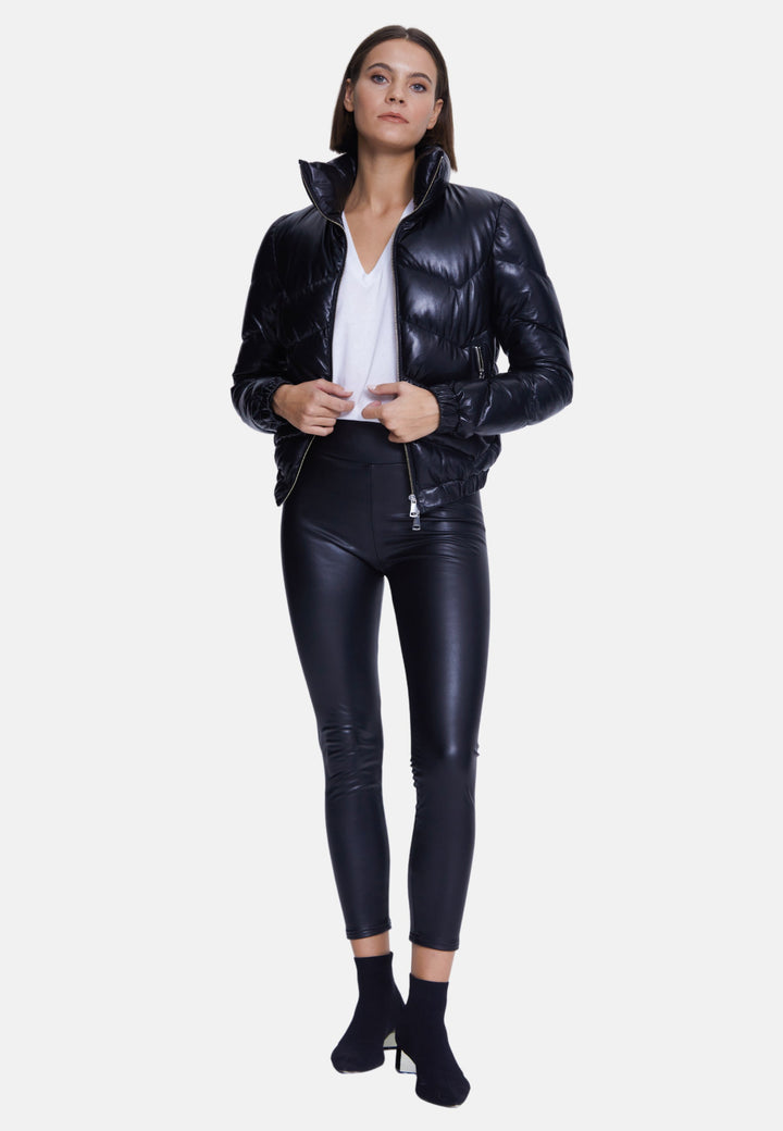 Woman wearing black shiny puffer leather jacket
