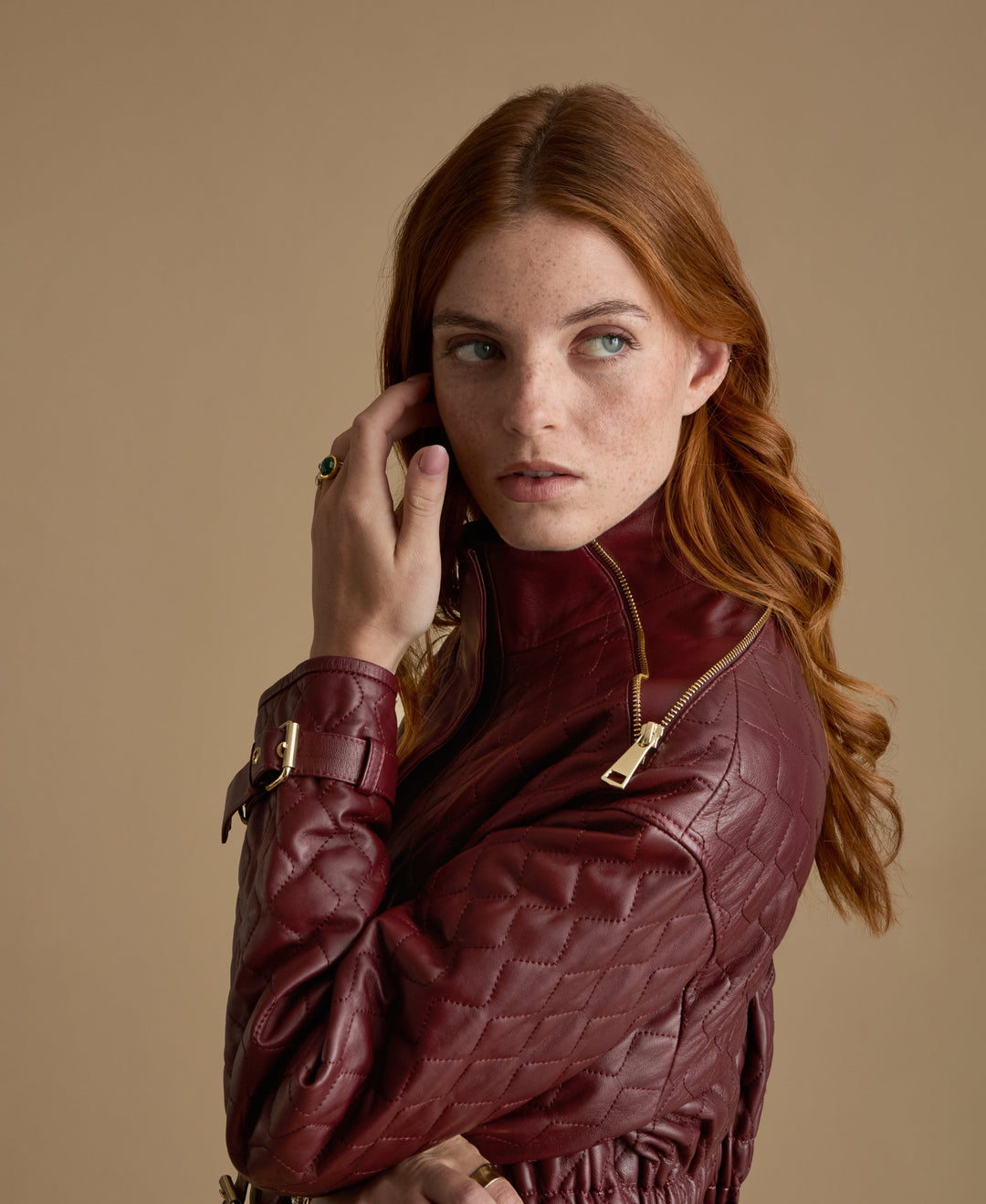 Burgundy quilted leather coat on model