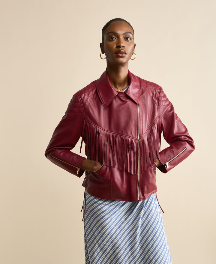 Front view of Dakota light burgundy fringed leather jacket with fringe detail