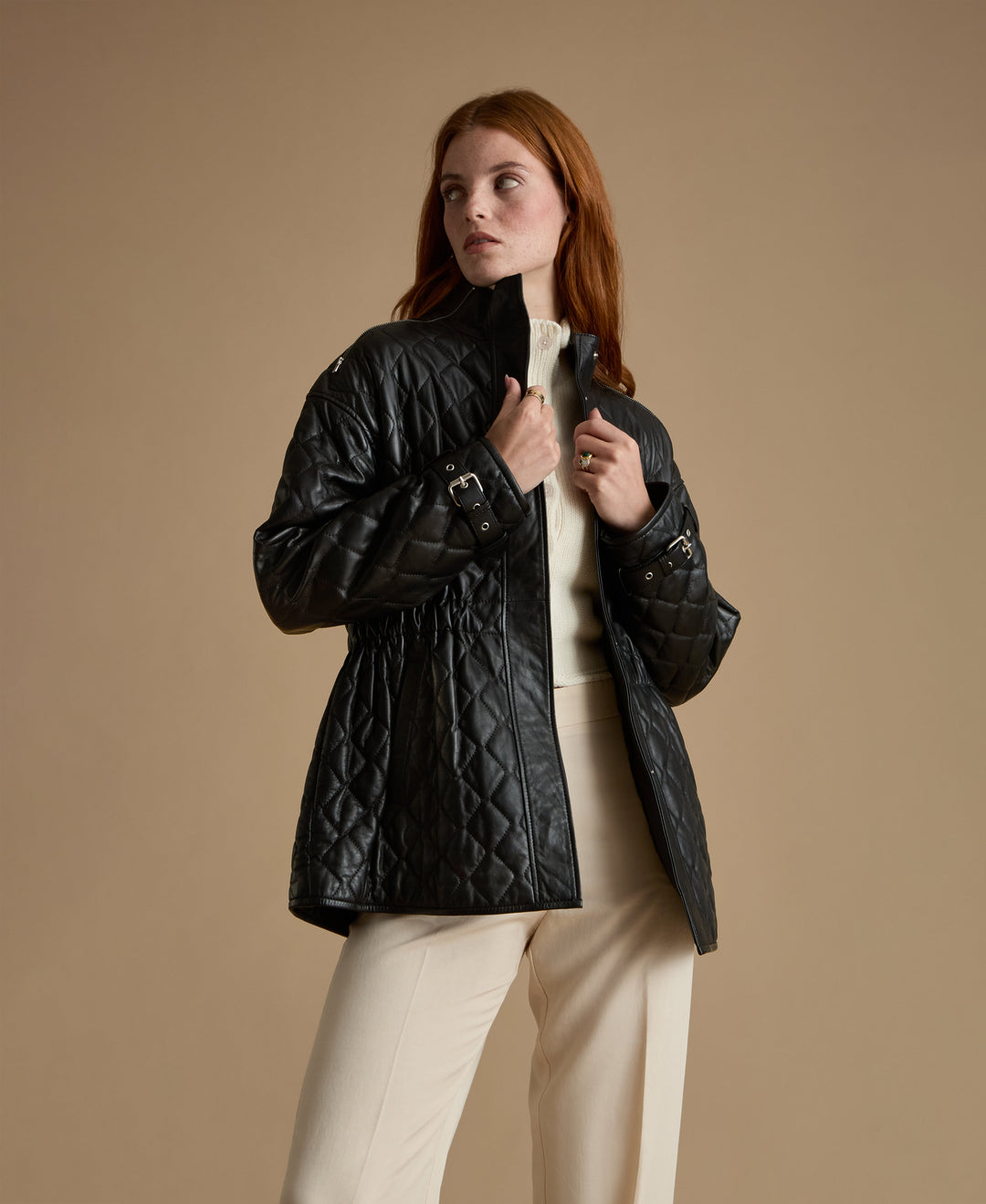 Woman wearing black quilted leather coat