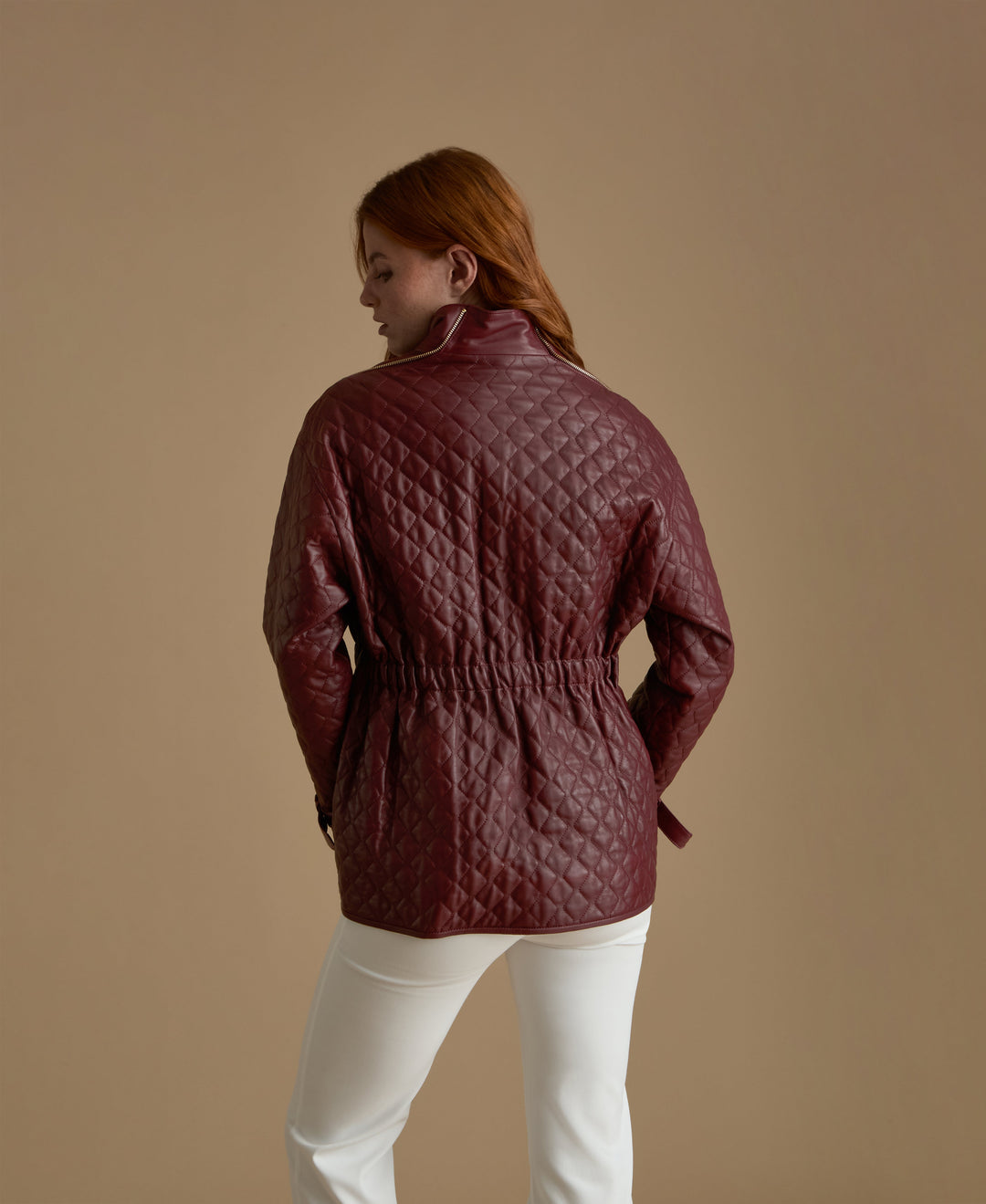 Woman wearing quilted burgundy leather jacket