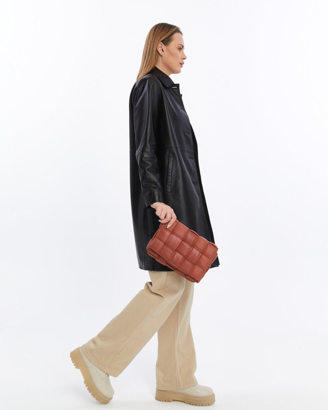 Cognac quilted leather handbag held by model
