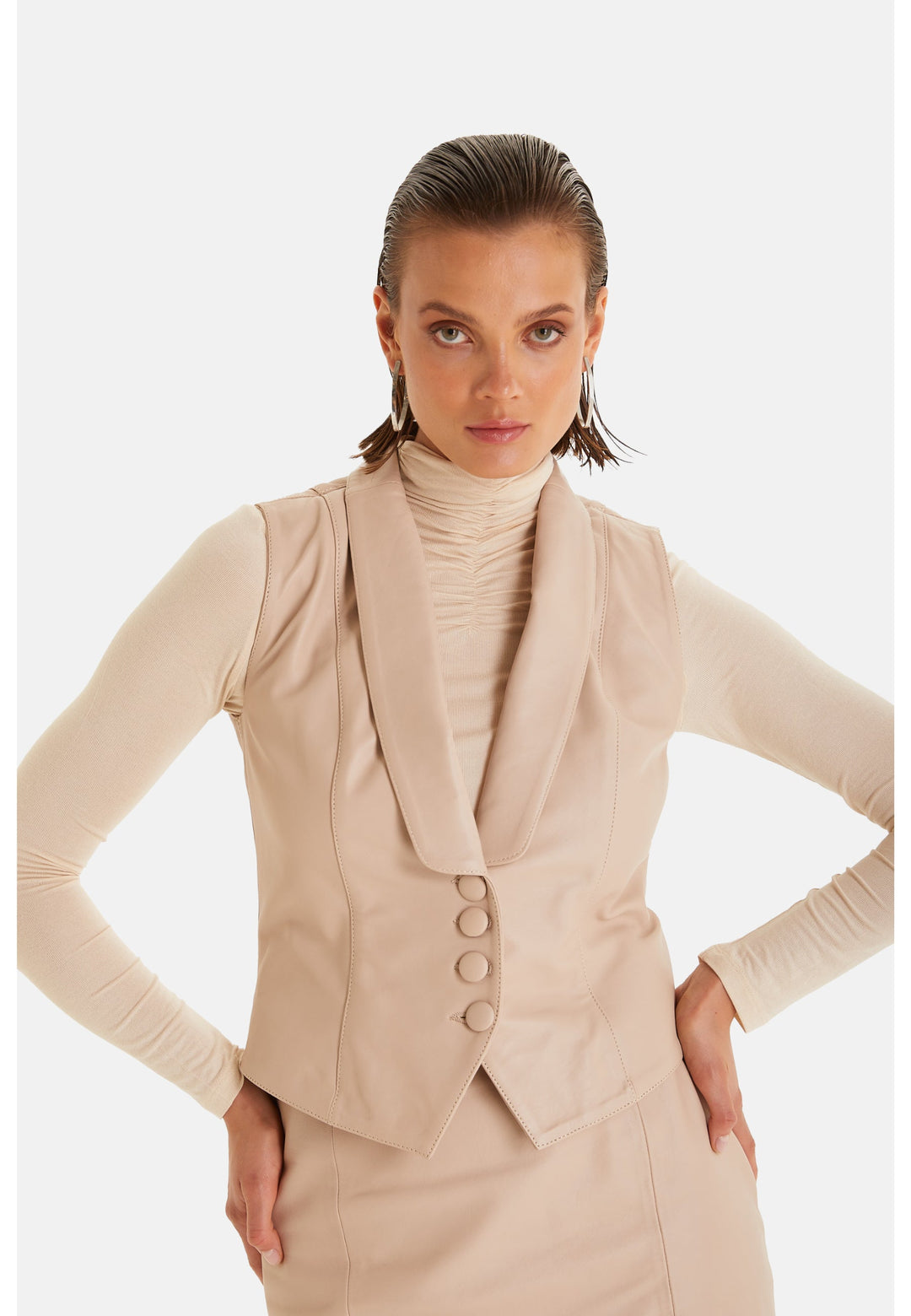 Woman wearing beige leather vest