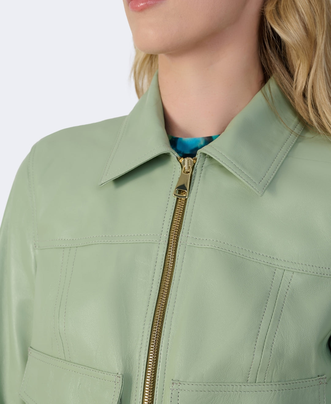 Sage green leather jacket close-up