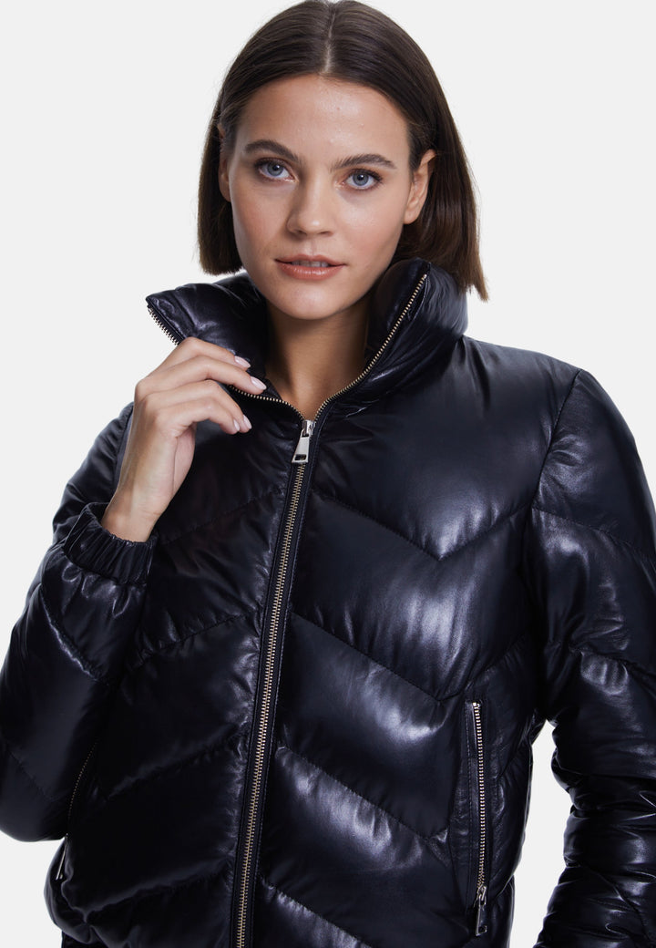 Woman wearing black glossy quilted jacket