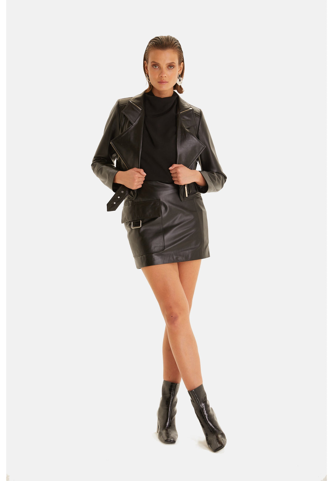 Woman wearing black leather jacket and skirt
