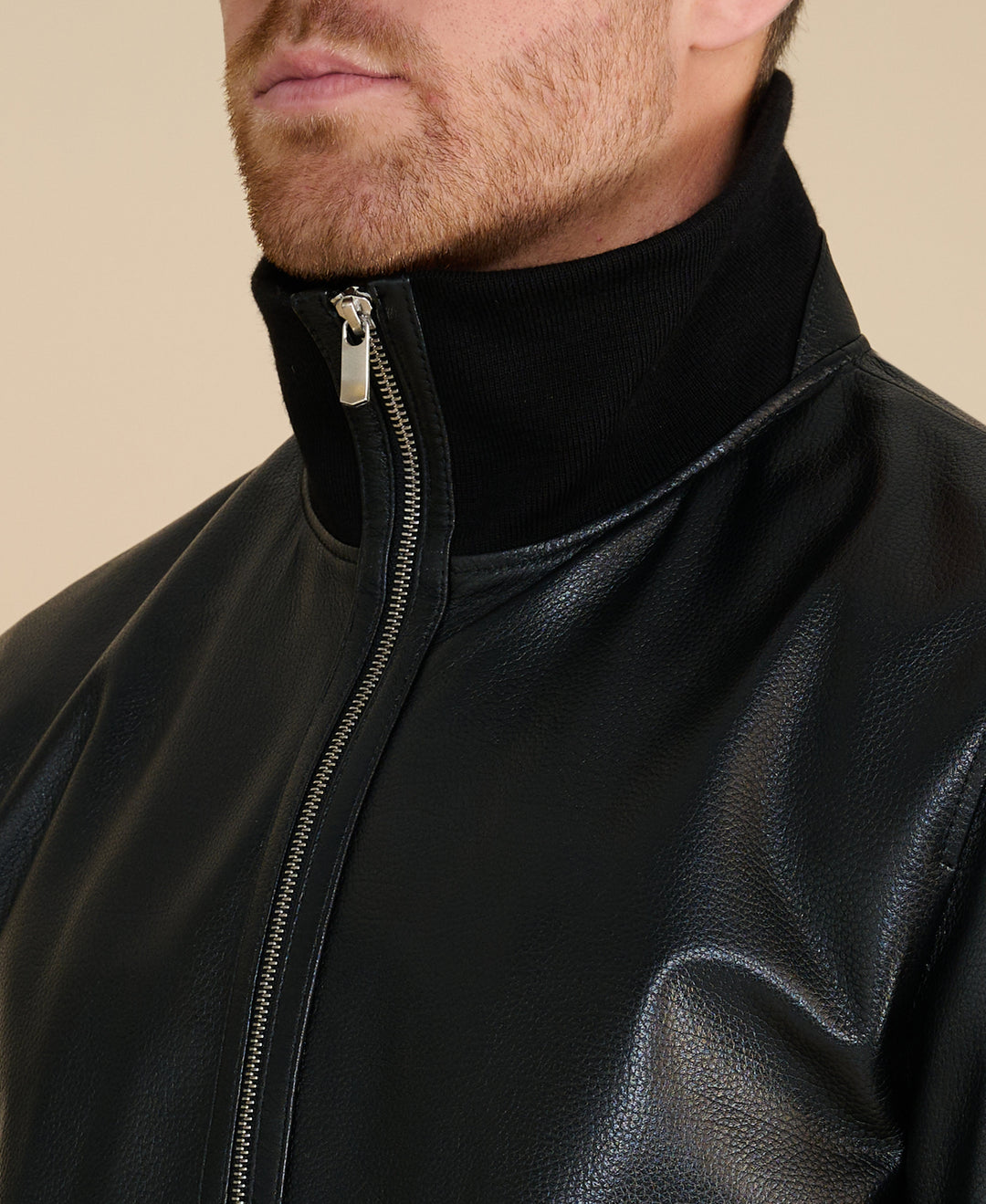 Men's black leather jacket close-up