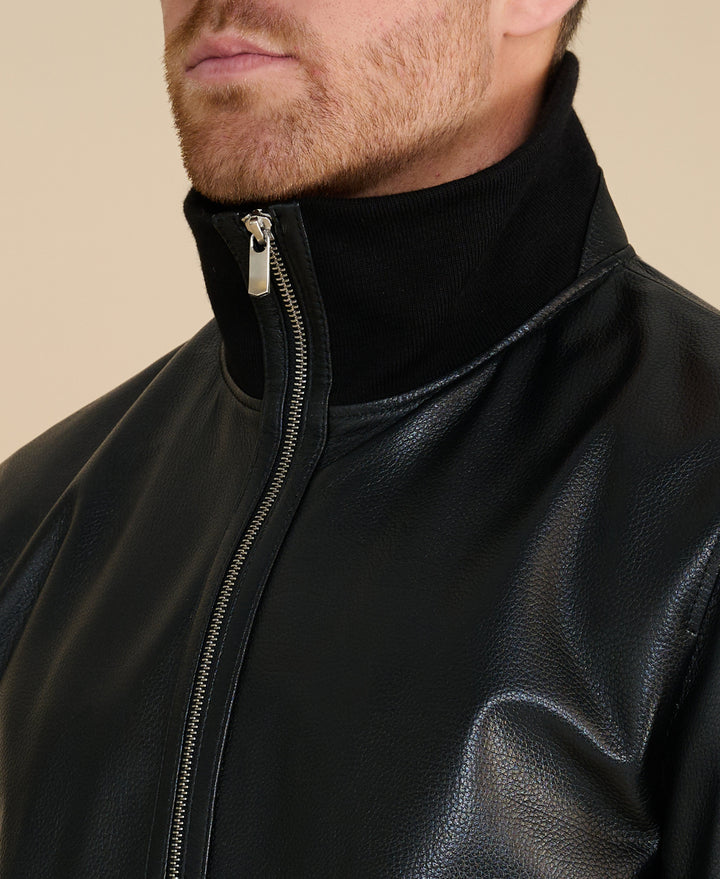 Men's black leather jacket close-up