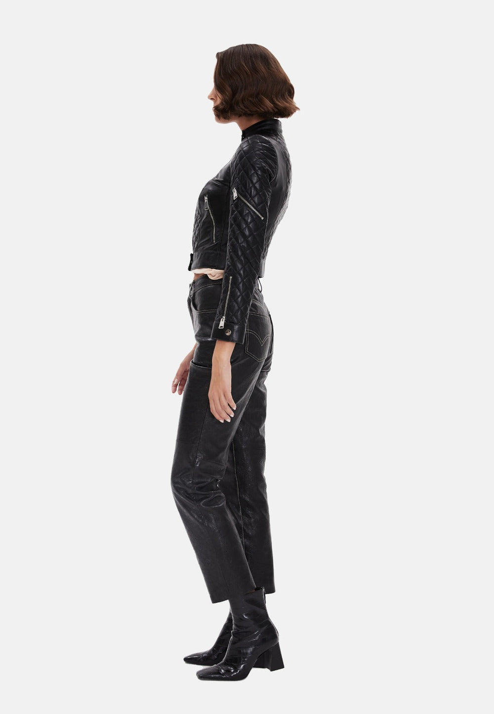 Woman in black leather outfit - side view